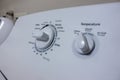 Angled, selective focus on the knob control panel of a white clothes dryer Royalty Free Stock Photo