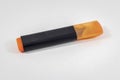 Angled shoot of orange colored highlighter pen with white background