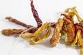 Angled shot dried orange colored peppers on white background