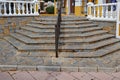 Angled steps lead from the road to a shopping area in Estepona, Spain