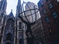 An angled view of the Atlas statue facing Saint Patrick s Cathedral church at Rockefeller Center. Royalty Free Stock Photo