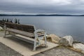 Angled view behind a wooden park bench with the Tacoma city skyline off in the horizon