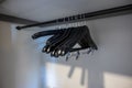 Angled view of black wooden hangers with clips inside a clean, white hotel room closet Royalty Free Stock Photo