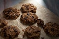 Angled view of fresh made cookies on baking paper.