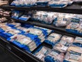 Woodinville, WA USA - circa September 2021: Angled view of fresh, raw packaged chicken breasts and thighs in a Haggen grocery