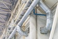 Angled view of an industrial ductwork system, primarily metallic gray and white Even lighting, no text or people visible Royalty Free Stock Photo