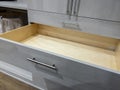 view of an open, empty dresser drawer inside a large, spacious walk in closet