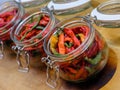 Angled view of open glass jars with canned hot pepper. The jar is prepared for clogging after pickling. The culinary delicacy of Royalty Free Stock Photo