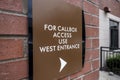 View of a sign pointing the direction of a callbox at a large apartment complex