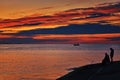 Angler on the Baltic Sea embankment in the sunset