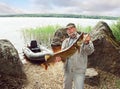 Angler catch big pike fish, fishing with boat Royalty Free Stock Photo