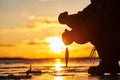 The angler fisherman at ice winter fishing. Sunset