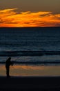 Angler with fishing rod on the beach