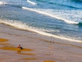 Angler with fishing rod on sea shore