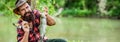 Angler with fishing trophy. Fisherman and trout. Fishing backgrounds. Man hold big fish trout in his hands. Fisherman Royalty Free Stock Photo