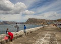 Angler on the harbor wall at Kalk Bay South Africa Royalty Free Stock Photo