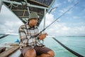 angler holding a fishing rod and checking the reel Royalty Free Stock Photo