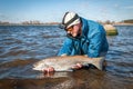 Angler releasing the fish Royalty Free Stock Photo