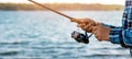 angler retrieve fishing reel line closeup. copy space Royalty Free Stock Photo