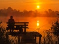 Fishing by the sunrise in the lake. Royalty Free Stock Photo