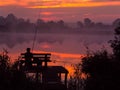 Fishing by the sunrise in the lake. Royalty Free Stock Photo