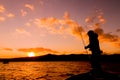 Anglers on a boat fishing in the lake in the evening Royalty Free Stock Photo