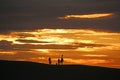 Anglers on Chesil Bank at sunset Royalty Free Stock Photo