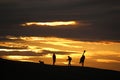 Anglers on Chesil Bank at sunset Royalty Free Stock Photo