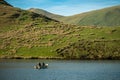 Anglers fishing from a boat on Llyn Dywarchen in the Eryri National Park, Wales