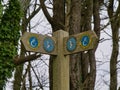 Anglesey, UK - Jan 11 2024: A weathered, wooden sign pointing the way for walkers on the Wales Coast Path on the island Anglesey Royalty Free Stock Photo