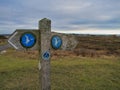 Anglesey, UK - Jan 11 2024: A weathered, wooden sign pointing the way for walkers on the Wales Coast Path on the island Anglesey Royalty Free Stock Photo