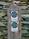 Anglesey, UK - Jan 11 2024: A weathered, wooden sign pointing the way for walkers on the Wales Coast Path on the island Anglesey Royalty Free Stock Photo