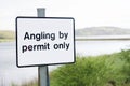 Angling by permit only sign at freshwater lake