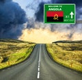 Angola road sign against clear blue sky Royalty Free Stock Photo
