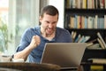 Angry adult man checking laptop online content in a bar