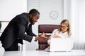 Angry African American boss scolds woman office worker. A demanding manager-manager is annoyed by laziness and mistakes