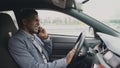 Angry mixed race businessman talking phone while sitting inside his car outdoors Royalty Free Stock Photo