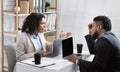 Angry African American woman having fight with her collague at company office, copy space Royalty Free Stock Photo