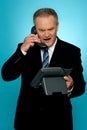 Angry aged corporate man yelling on phone Royalty Free Stock Photo