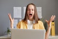 Angry aggressive frustrated freelancer young woman spent working online in home office looking at laptop screen with dissatisfied Royalty Free Stock Photo