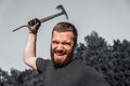 Angry aggressive man with beard swings axe, closeup Royalty Free Stock Photo