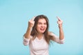 Angry aggressive woman with ferocious expression on blue background Royalty Free Stock Photo