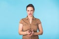 Angry aggressive woman with ferocious expression on blue background Royalty Free Stock Photo