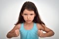 Angry and aggressive young girl with clenched fists