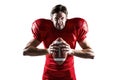 Angry American football player in red jersey holding ball