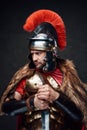 Angry ancient rome soldier against dark background