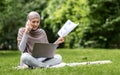 Angry arab woman freelancer working at park, talking on phone Royalty Free Stock Photo