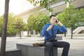 Angry asian businessman while talking on his cellphone Royalty Free Stock Photo