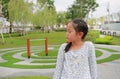 Angry Asian young girl kid turn her face to the side and eyes closed while sitting in the garden outdoor Royalty Free Stock Photo