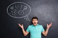 Angry astonished man shouting over blackboard background with speech bubble Royalty Free Stock Photo